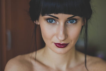 woman with maroon lipsticks and false mascara