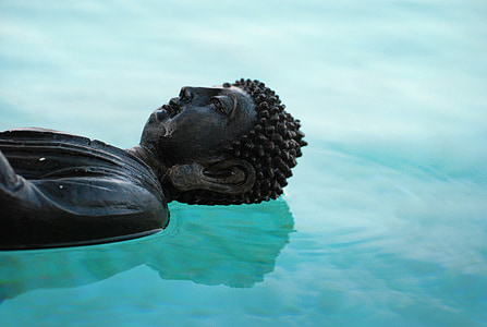 photo of Gautama Buddha on body of water
