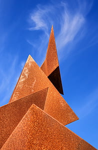 low-angle photo of triangle shaped under cloudy blue sky during daytime