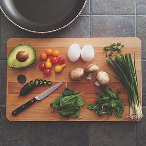 assorted vegetables and pair of eggs on chopping board