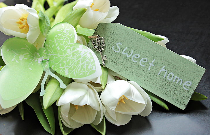 green and white flower arrangement with Sweet Home printed card