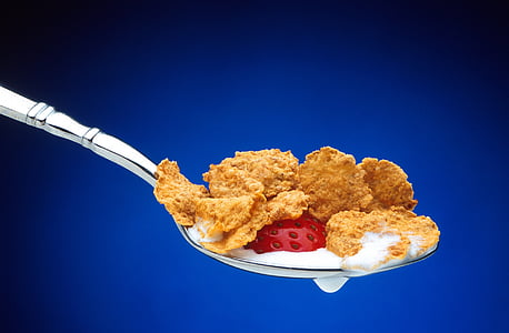 cereal on top of silver-colored spoon