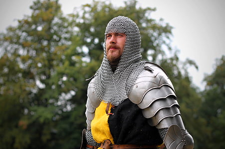 man wearing chain mail armor under bright sky