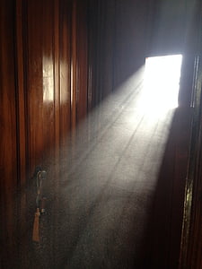 brown wooden door with white beam of sun