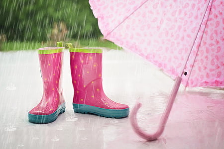 photo of pink wellington boots beside umbrella