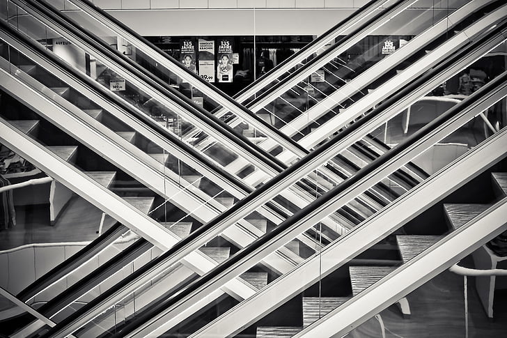 gray scale photo of escalators