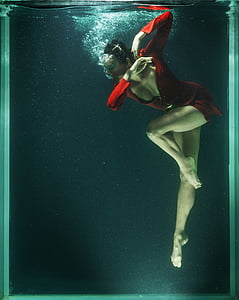 woman in red long-sleeved top inside an aquarium