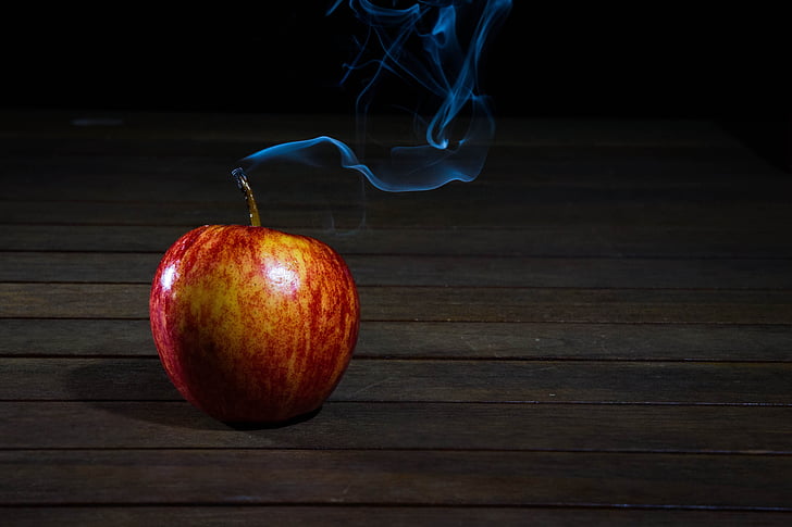 smoking apple fruit on plank