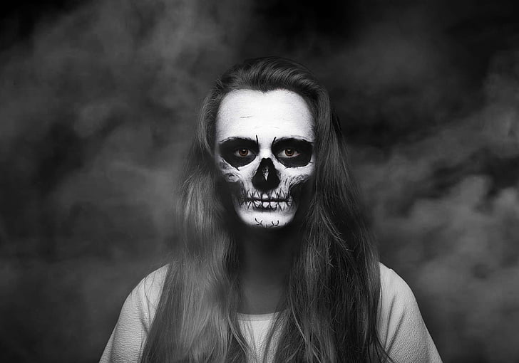 woman in black top with skull face paint