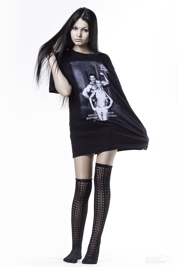 woman in black crew-neck shirt with black thigh-high socks