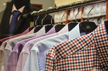 assorted-color dress shirts hanging on clothes rack