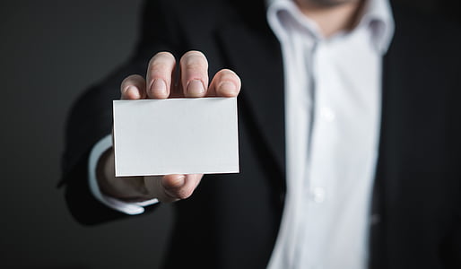 person holding white labeled box