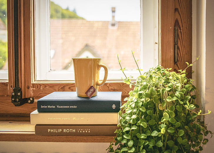 brown ceramic cup on book