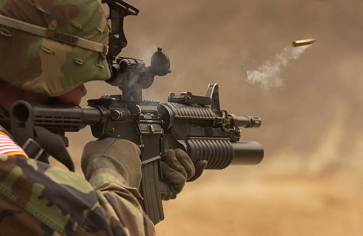 soldier firing M4 rifle