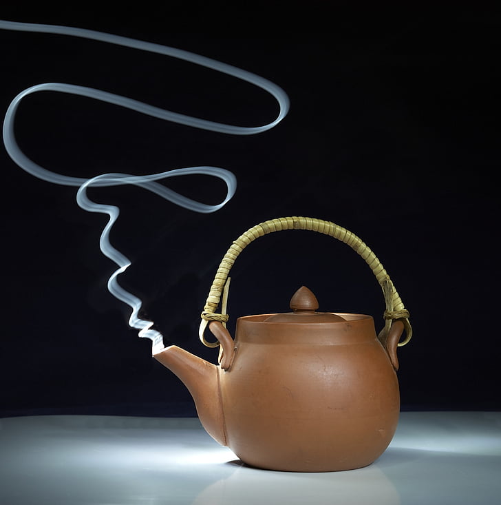 brown clay mold kettle with smoke