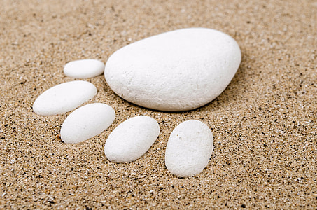 white stones on sand