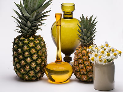 two pineapples and two brown glass vases