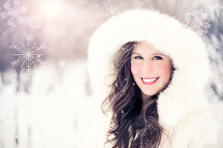 Well lit fashion portrait in a cold snowy day of a woman wearing a