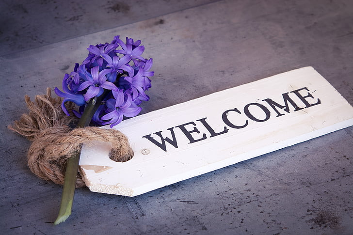 purple hyacinth and white wooden welcome tag