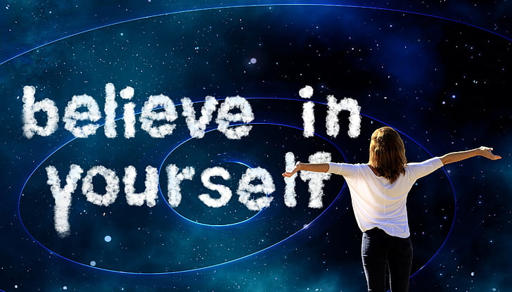 woman in white shirt spreading arms with believe in yourself text overlay
