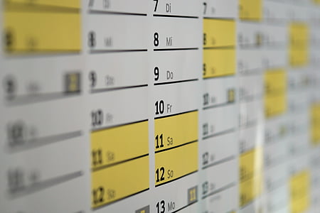 closeup photo of white, yellow, and black calendar