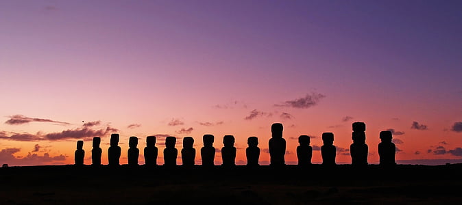 panoramic photo of Moai statues during golden hour