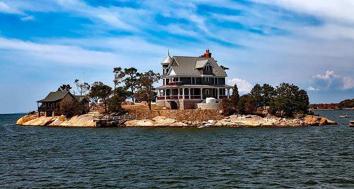 landscape photography of island with white and gray house during daytime