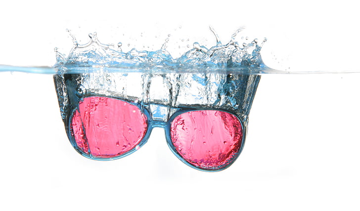 black framed red lens sunglasses in water