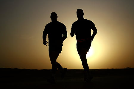 silhouette of two men