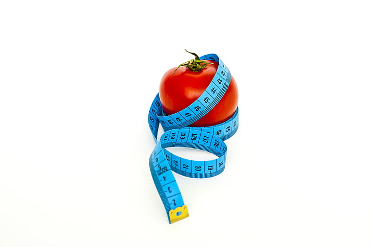 blue tape measure and red tomato