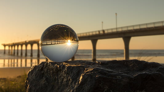 ball near bridge at sunset