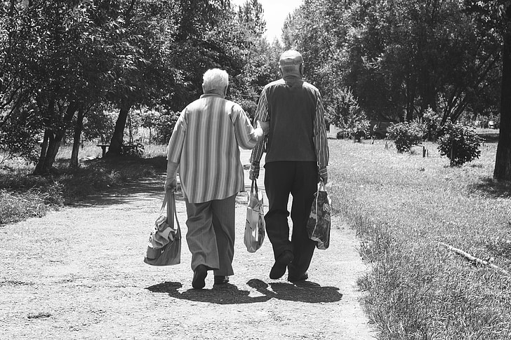 elderly couple walking black and white