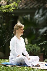 woman in white shirt meditating during daytime