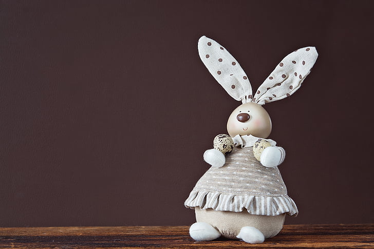 rabbit plush toy on wooden surface