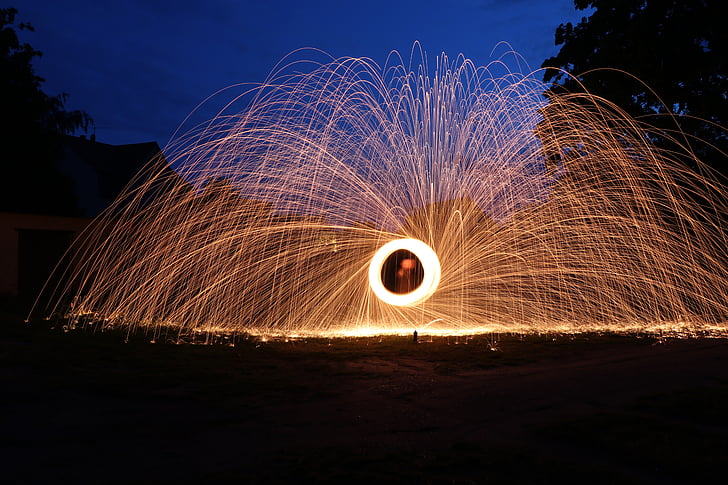 time lapse photography of round brown fireworks