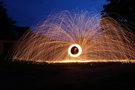 time lapse photography of round brown fireworks