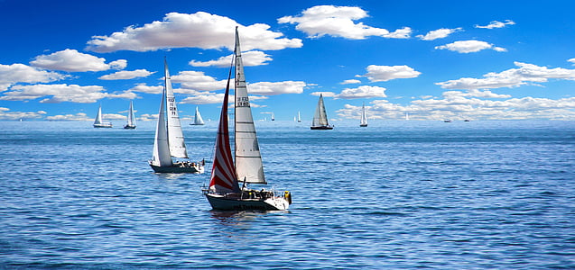 two white sailboats on body of water