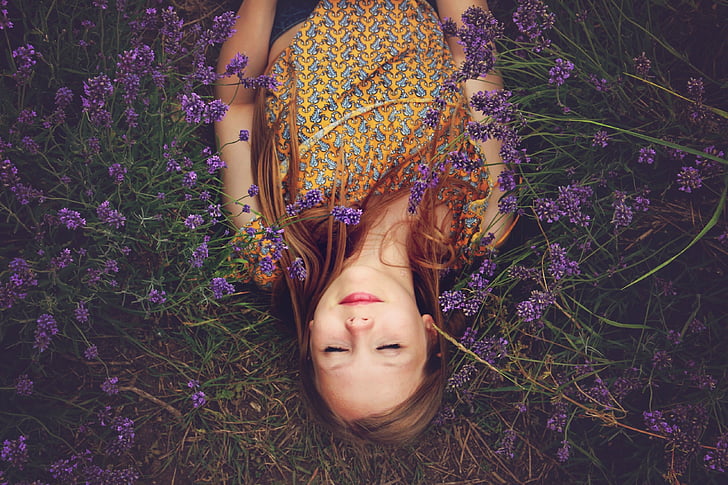 woman lying on purple flowers