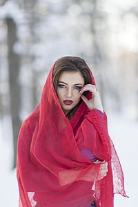 woman in purple top and red hijab veil