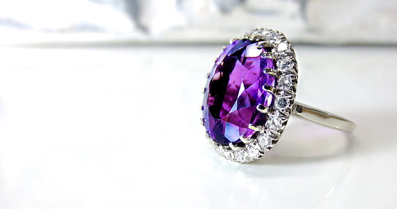 close up photo of purple gemstone solitaire ring