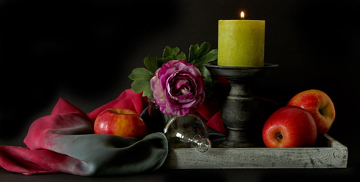 red apples beside gray candlestick