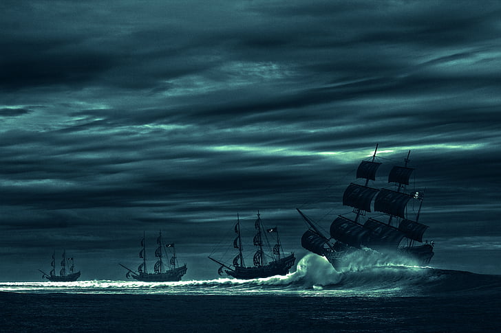 four galleon ships on sea with waves under gray sky