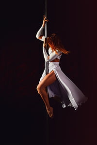 woman performing pole dance