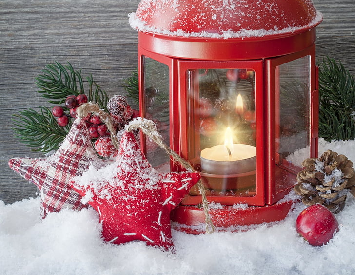 red tealight candle holder on snow flakes