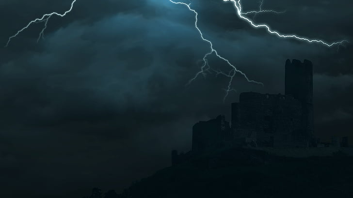 silhouette of buildings during thunder