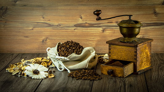 coffee beans and grinder on top of table