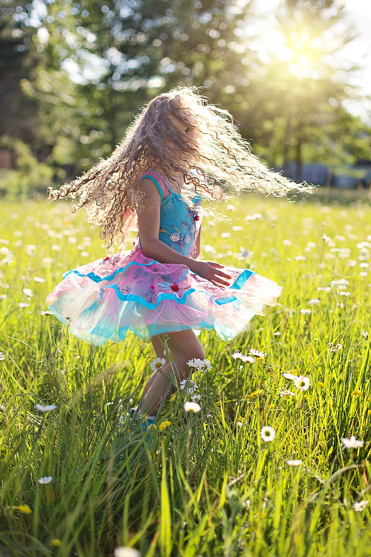 girl wearing dress in grass field