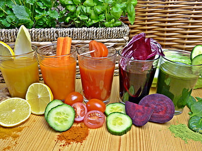 assorted fruit juices on clear drinking glasses