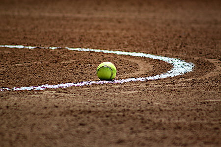 green baseball on brown and white surface