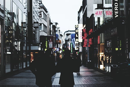 silhouette of people walking on street